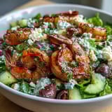 Colorful Greek Shrimp Bowl featuring juicy tomatoes, cucumbers, and creamy feta.