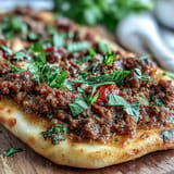 Crispy Turkish Lahmacun Pizza with ground lamb and sumac, served hot.
