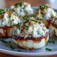 Crab cake deviled eggs with Old Bay, a zesty, seafood appetizer bite.